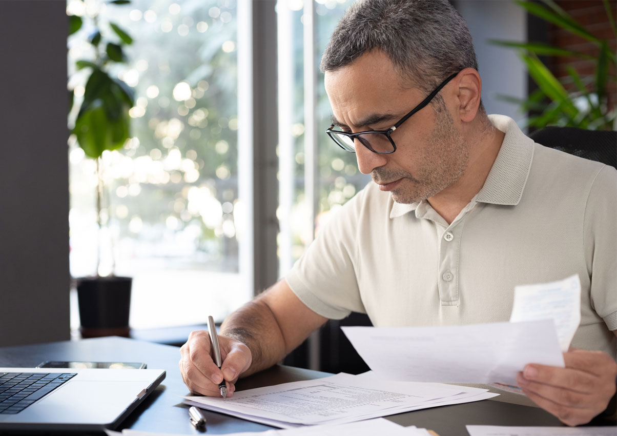 SPS customer reviewing mortgage paperwork at his desk